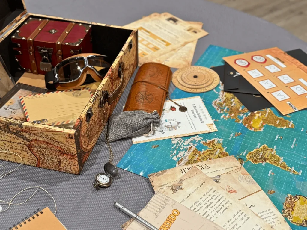 Escape rooms baratas para empresas: cofre, mapa, brújula y documentos de un juego portátil sobre una mesa