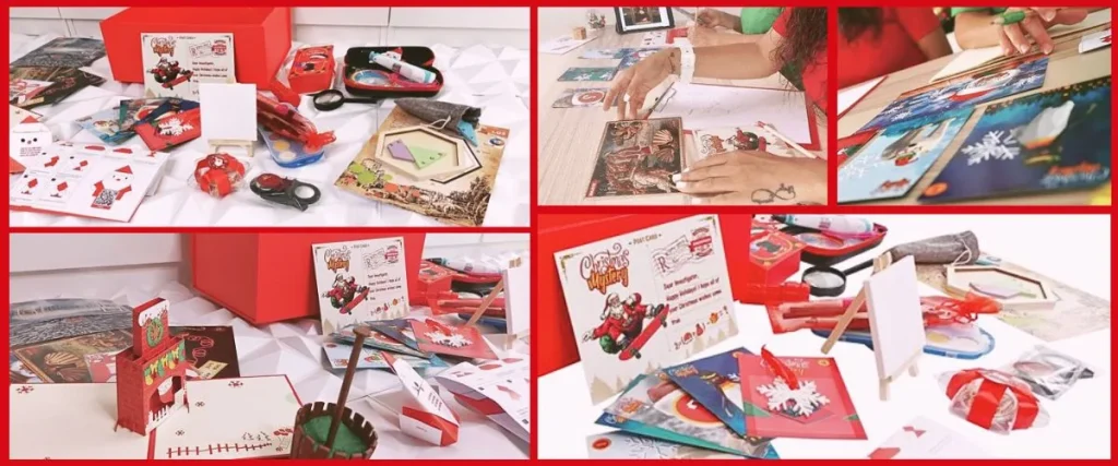 Juegos para cenas de empresa: material del escape room de Navidad, con cajas rojas, cartas y piezas de juego
